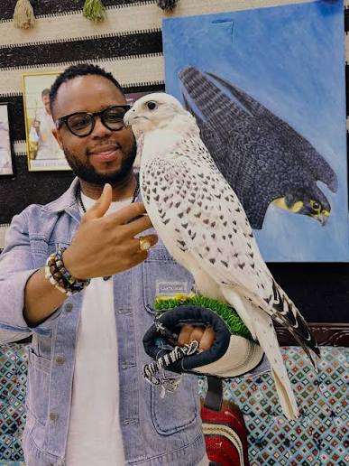 Visitor with a white gyrfalcon on the glove